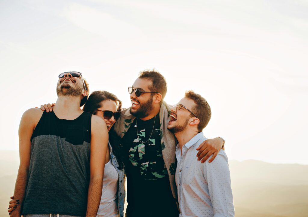 pexels photo 708440 708440 A group of young adults laughing and enjoying time together outdoors under the sun.